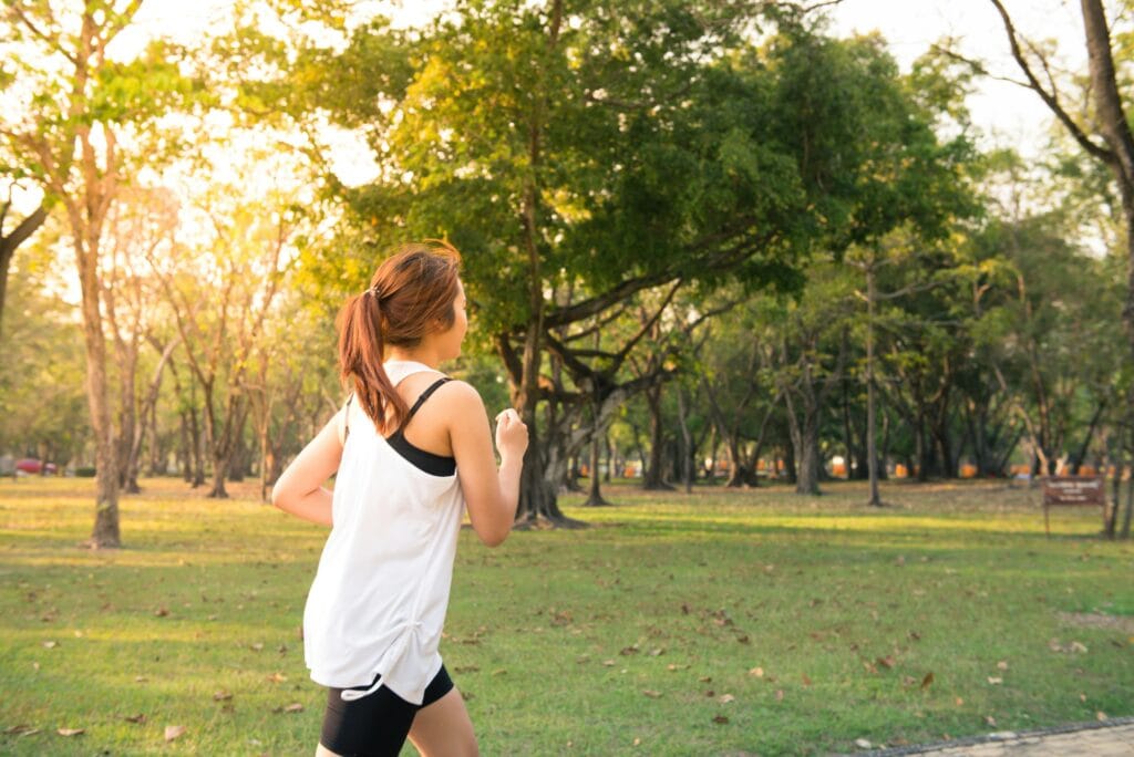 Motivated woman running in the morning to stay consistent with his fitness goals.