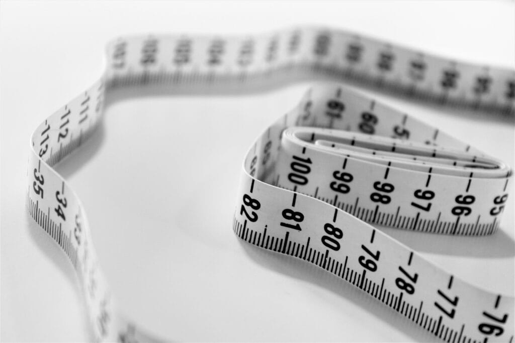 Measuring tape showing progress and results from a consistent fitness lifestyle