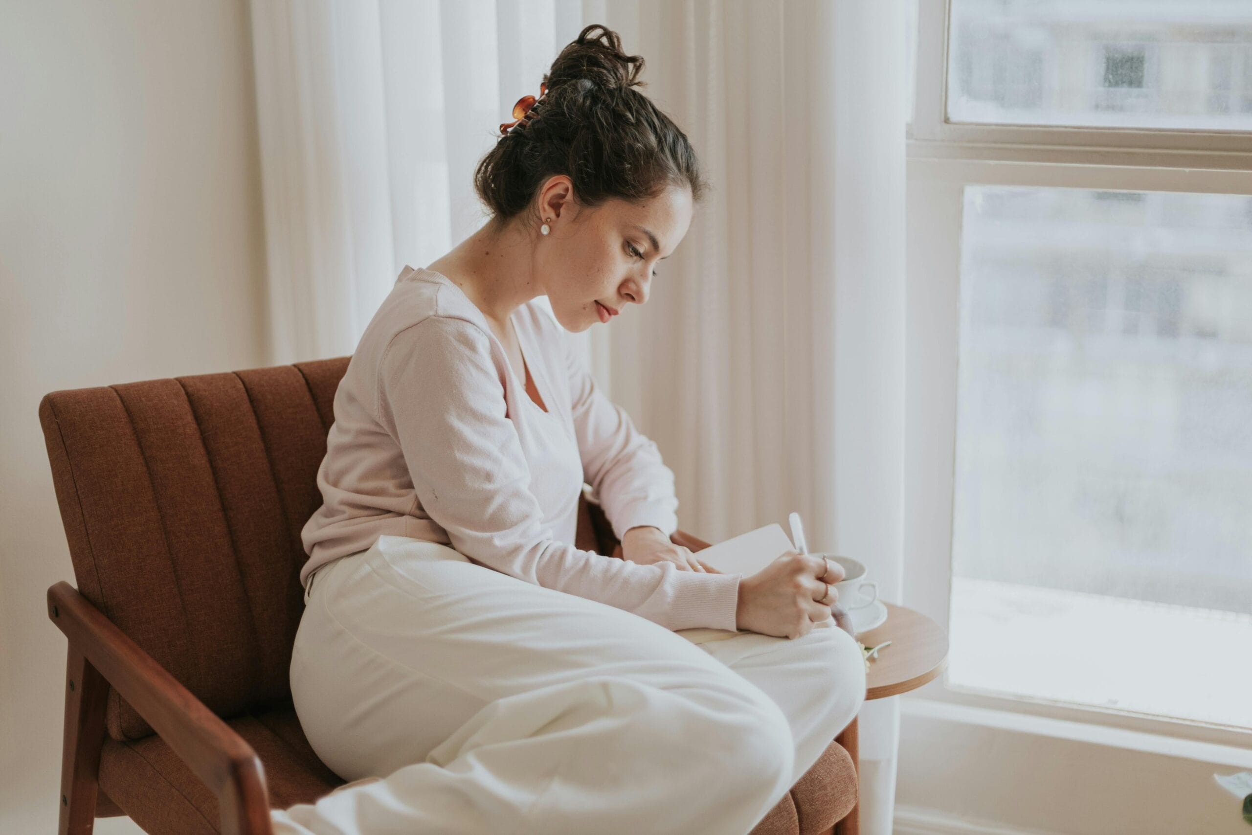 Woman writing fitness goals in a journal