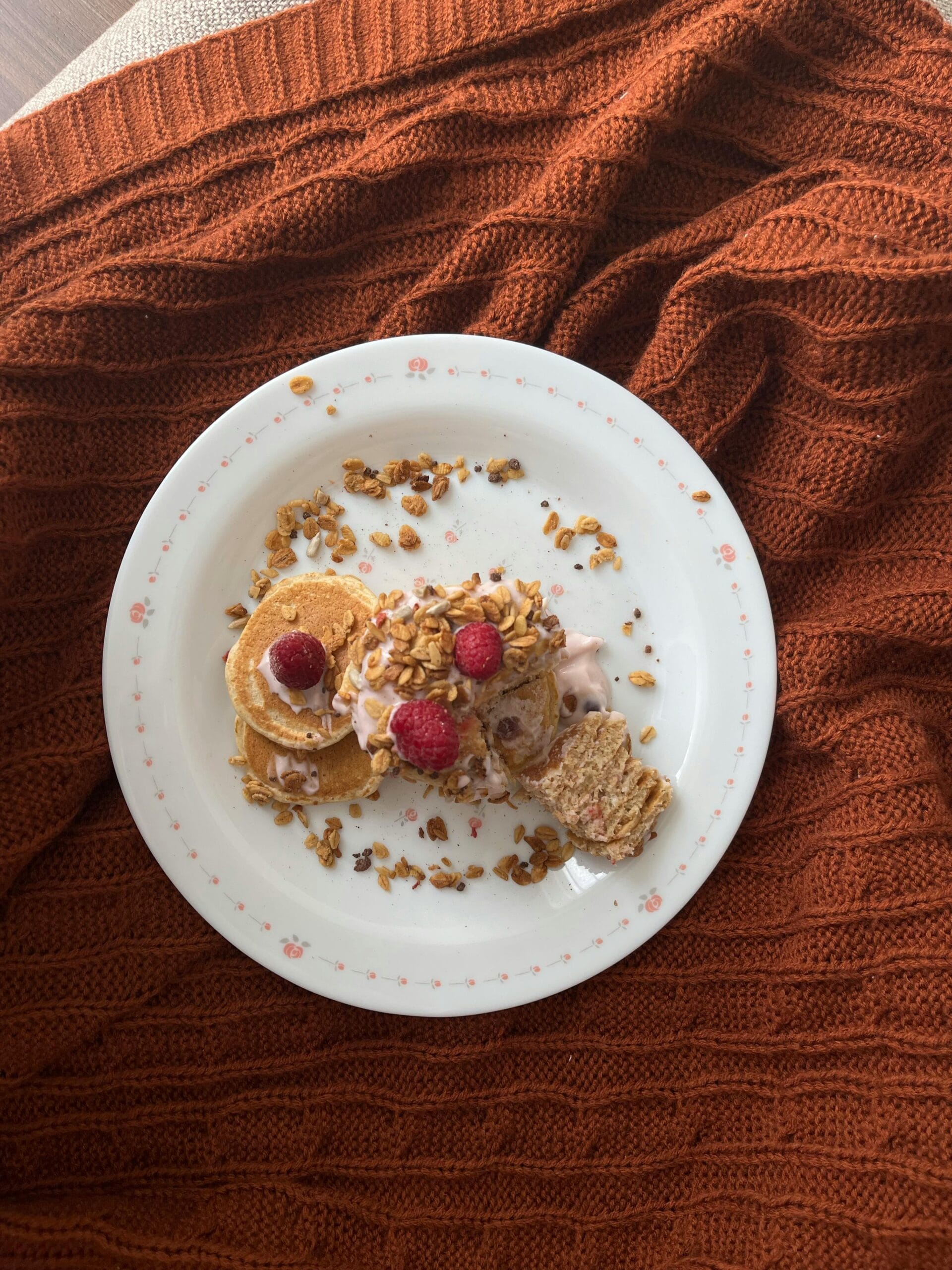 Oat pancakes topped with fresh berries, served as a wholesome morning meal.