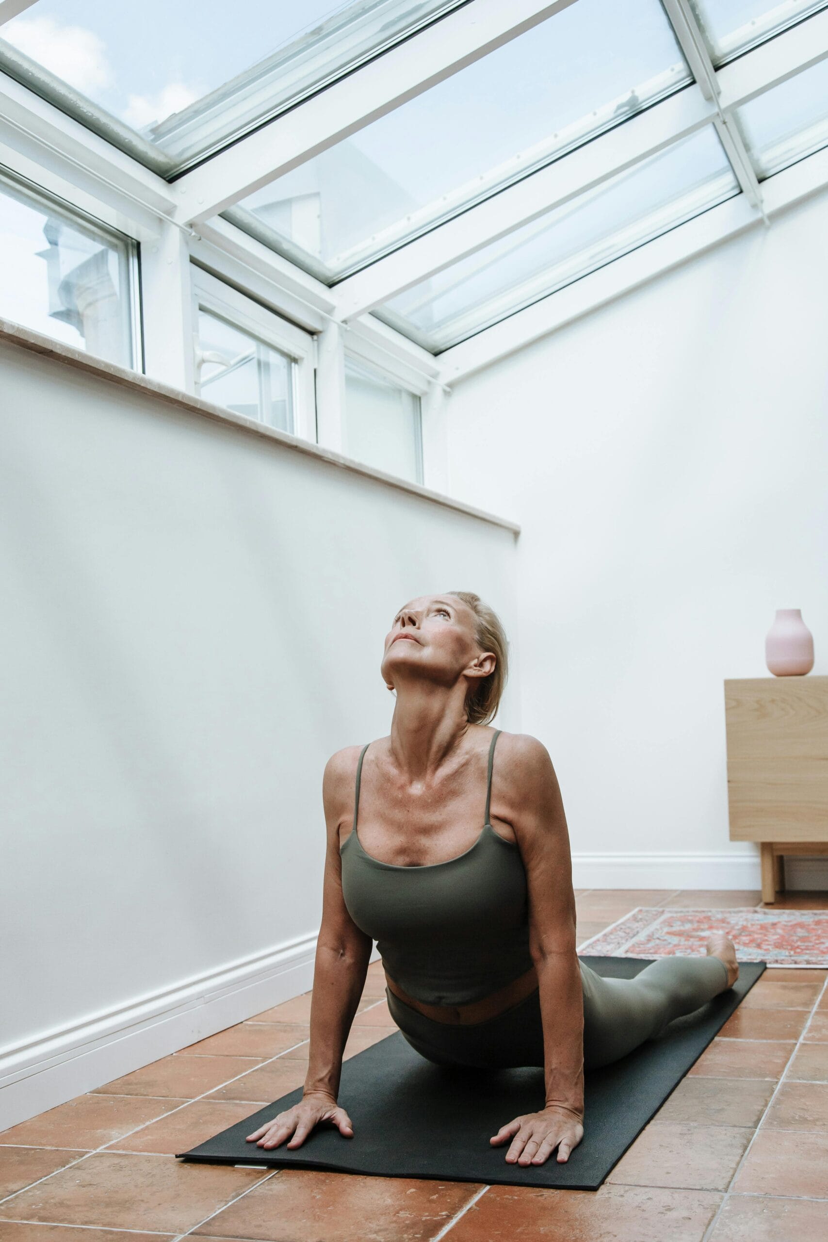 Woman working out at home in a calm, cozy environment, building motivation through comfortable exercise.