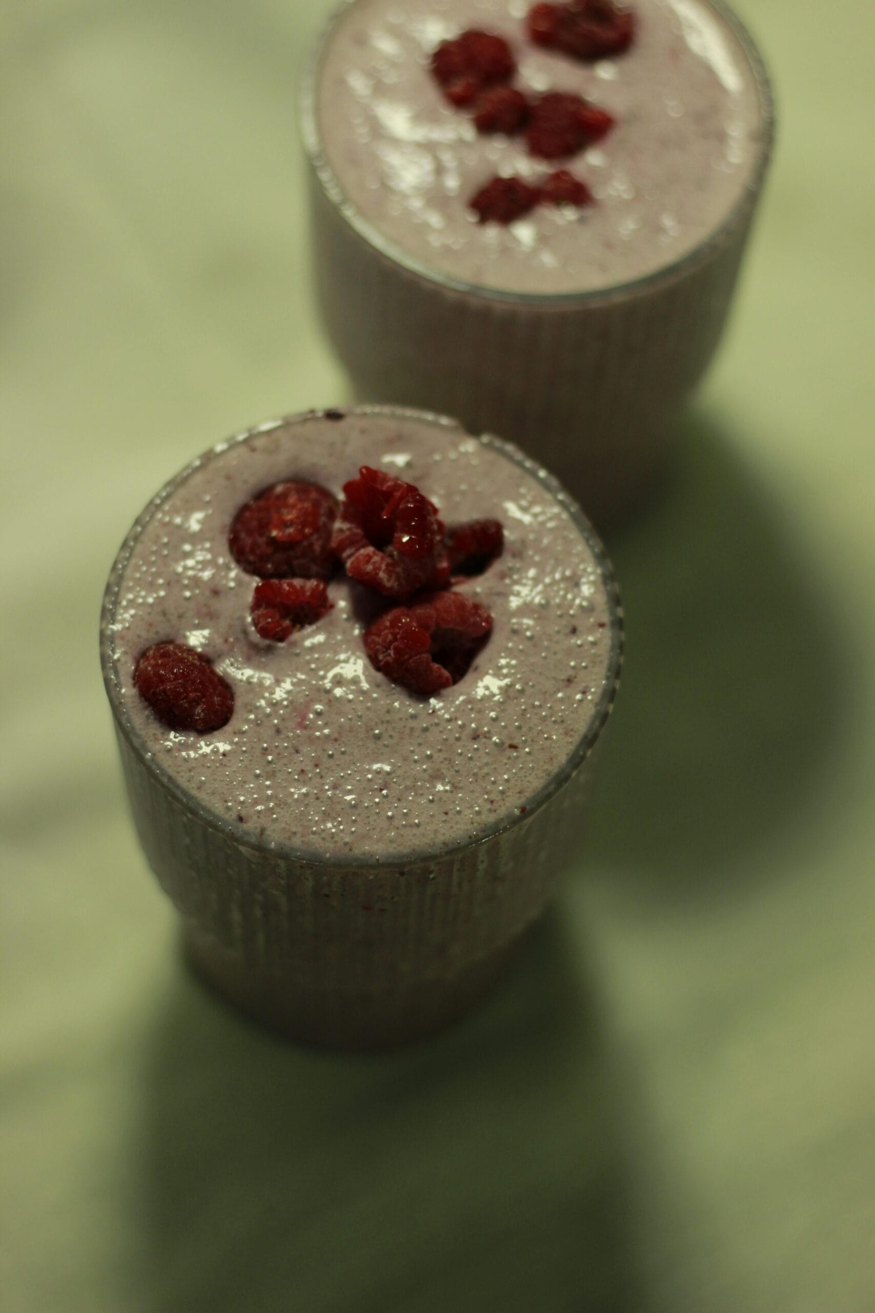 A berry and almond protein smoothie in a glass, blended into a nutritious morning drink.