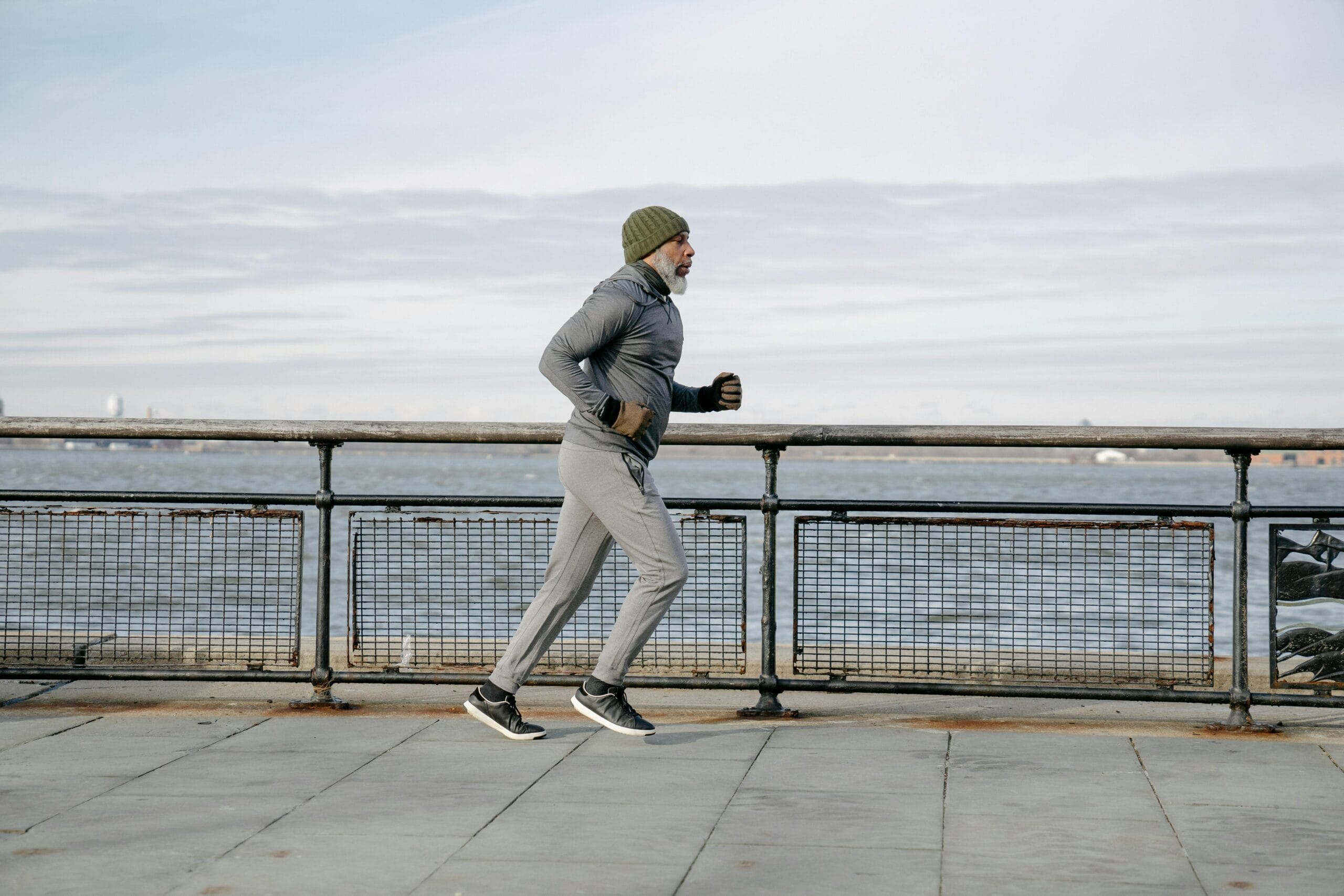 Man running outdoors early in the morning to maintain fitness during the winter.