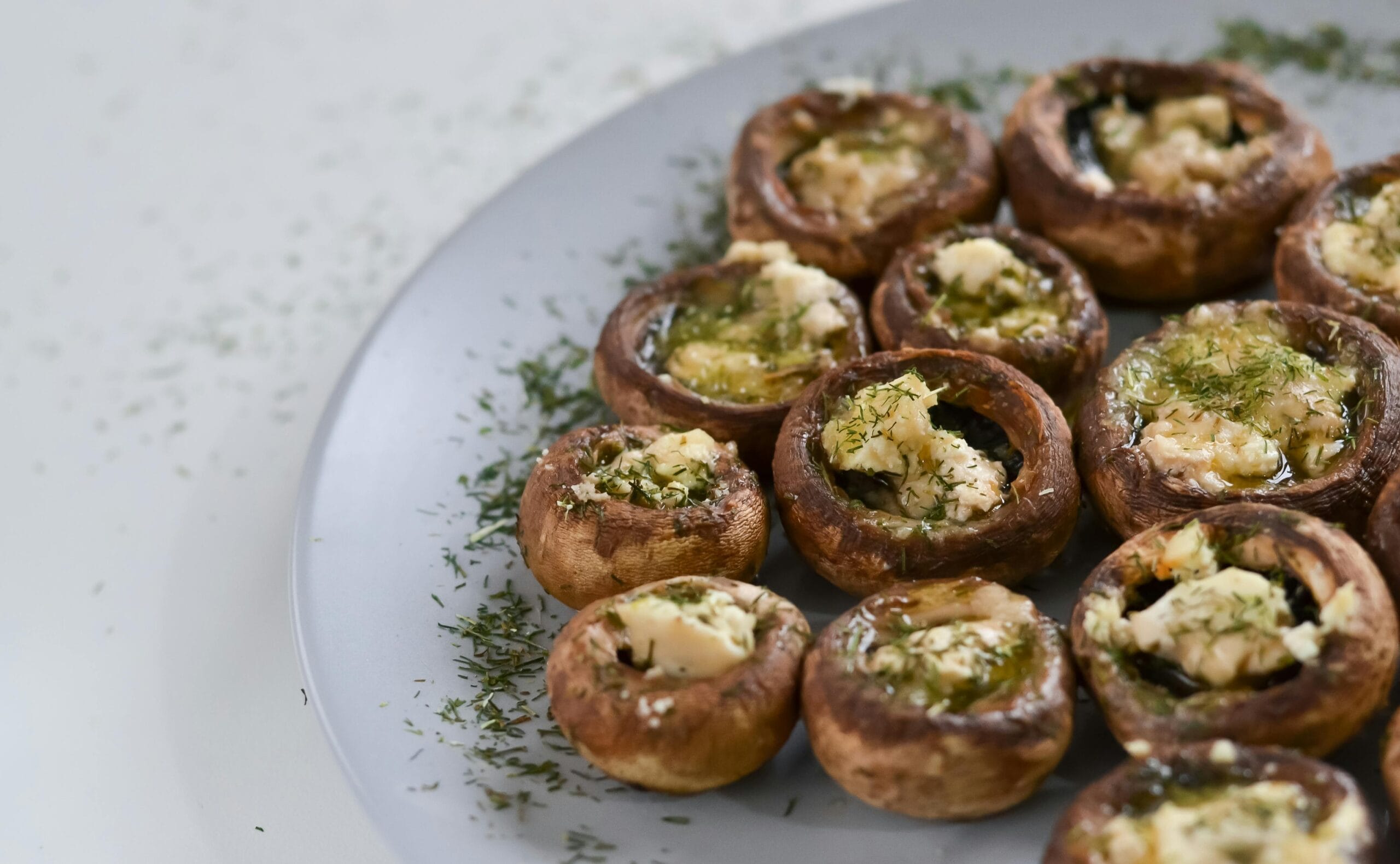 Baked stuffed mushrooms with spinach and feta cheese, a guilt-free appetizer for healthy holiday recipes.