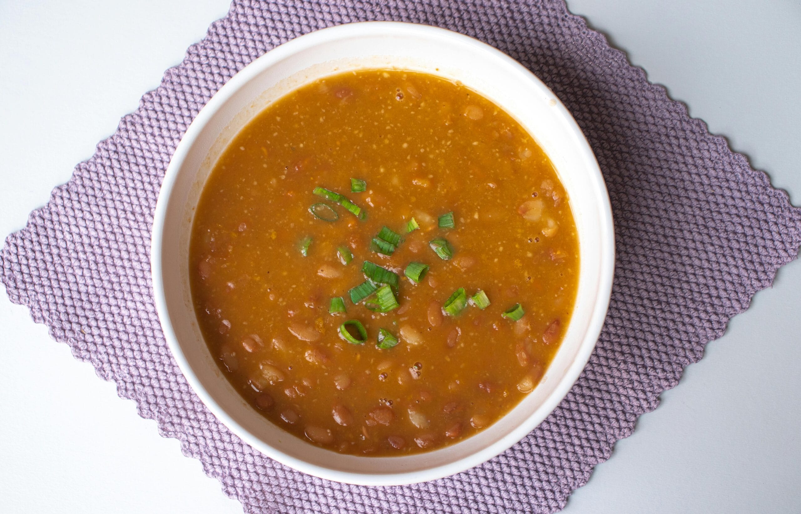 Bowl of lentil and vegetable soup with carrots and celery