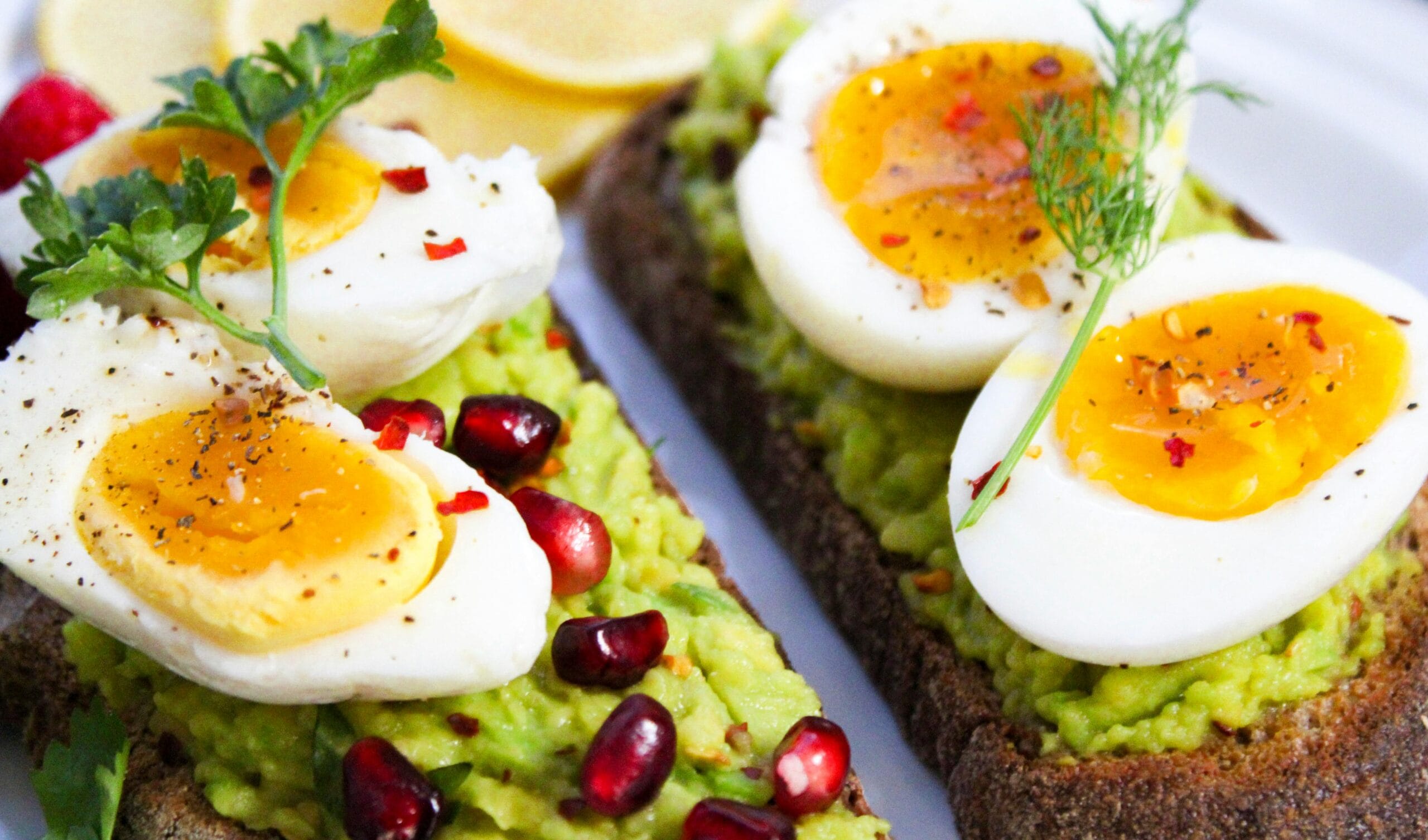 healthy avocado toast with eggs and pomegranate for balanced nutrition