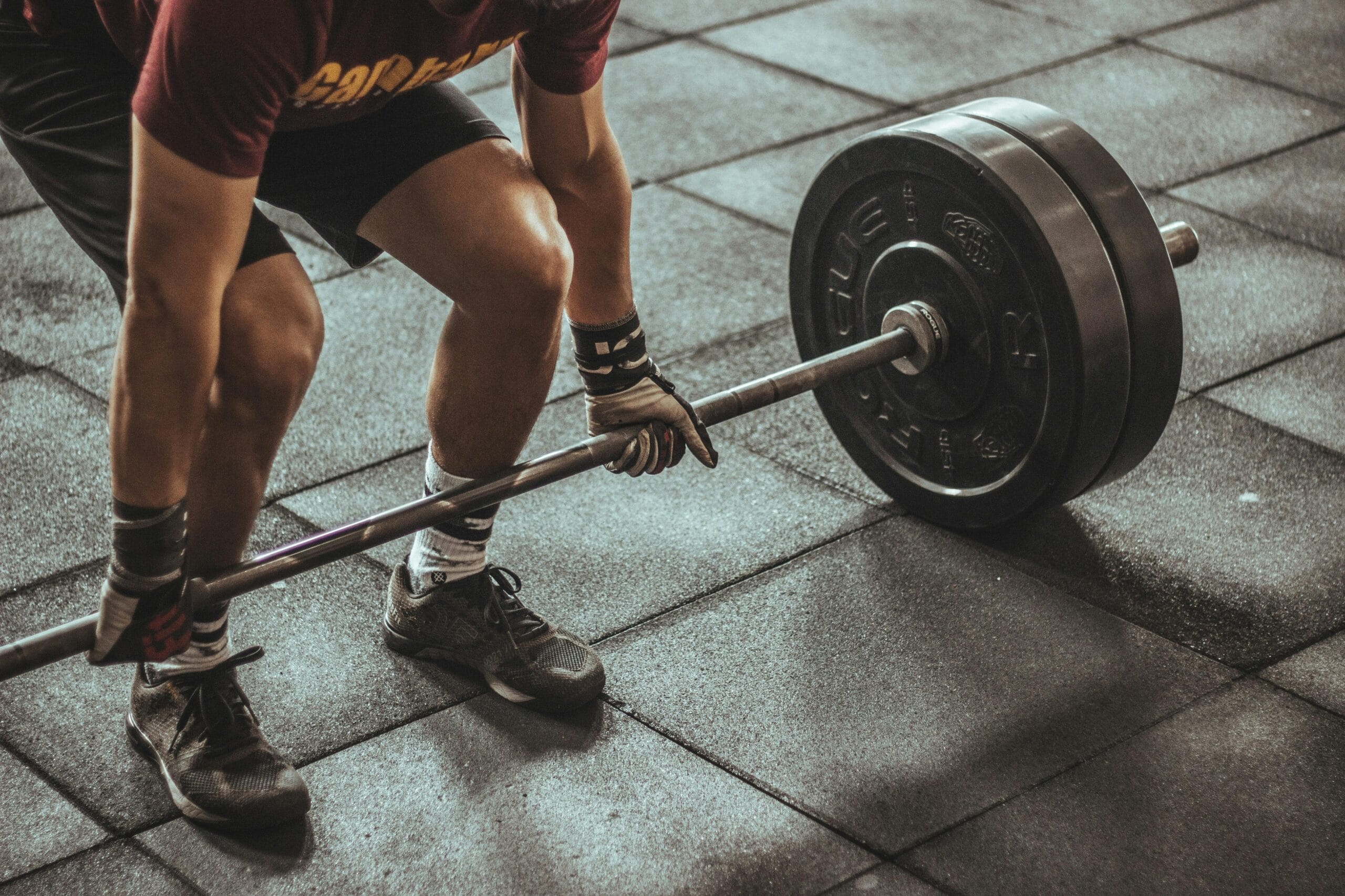 man lifting a barbell during strength training workout