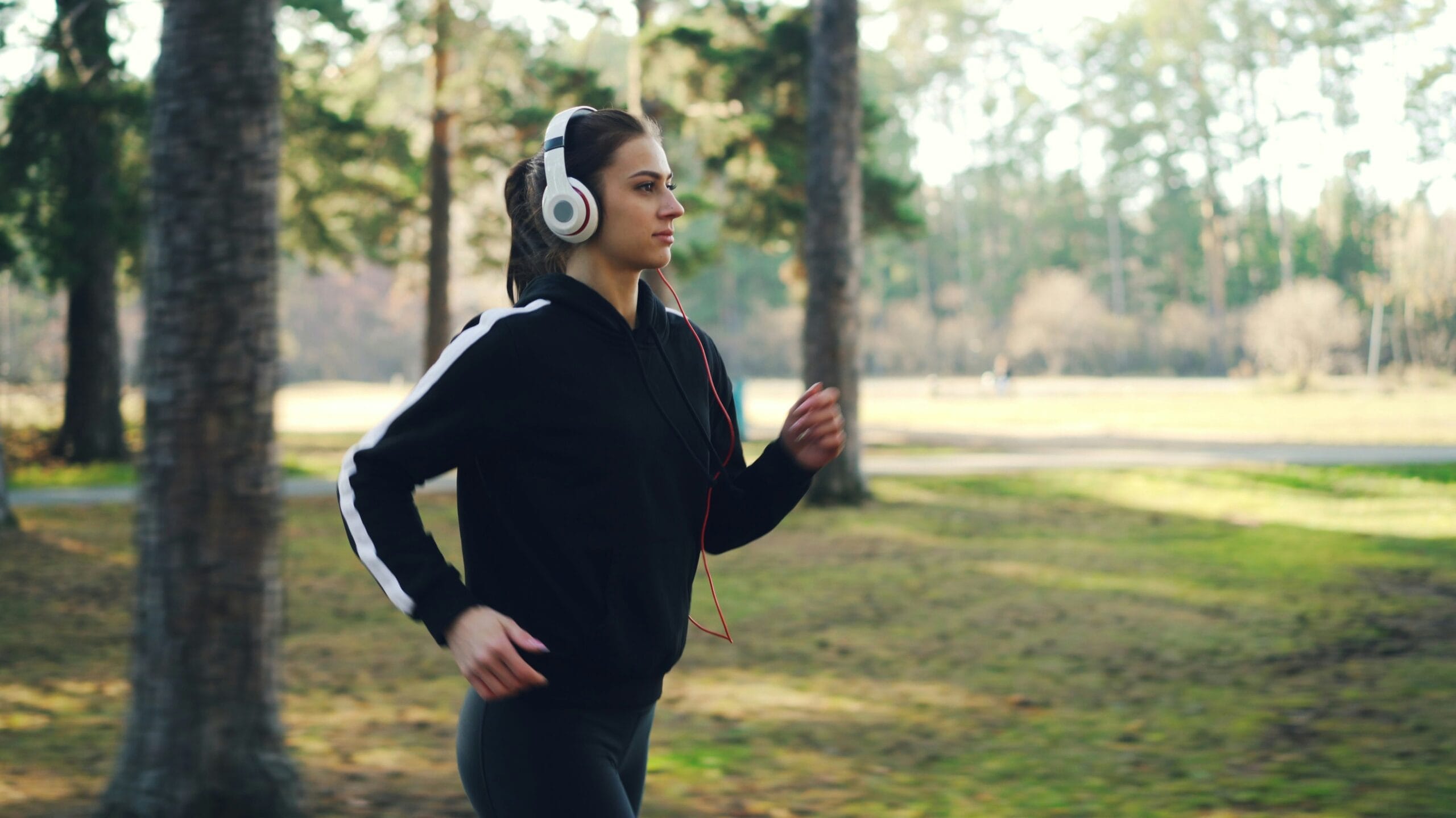 woman running outdoors and maintaining long term fitness motivation